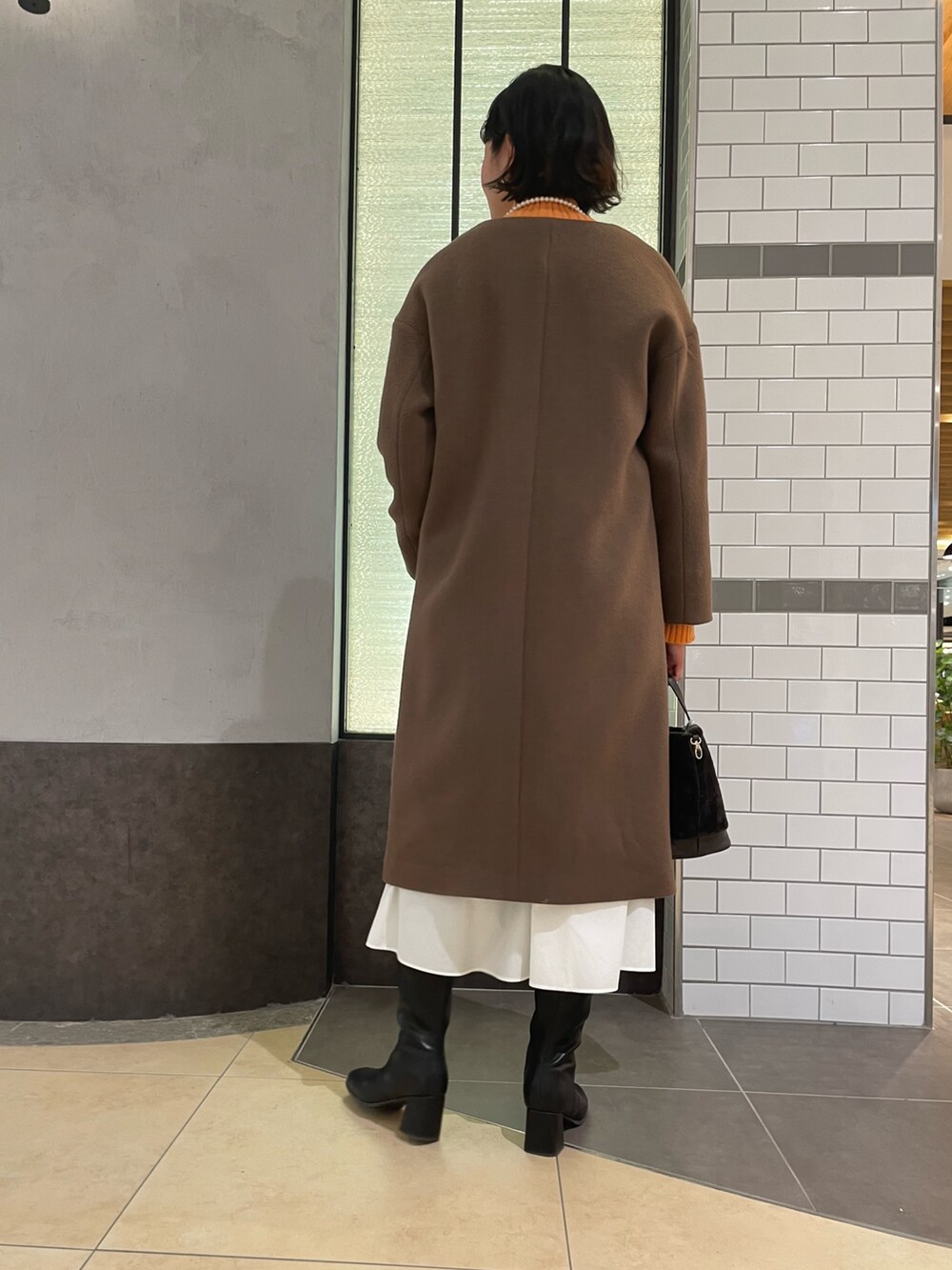 「オレンジニット、冬コーデ、コート、NOLLEY'S、ノーリーズ、ブラウンコート、ウールコート、ロングコート、ハイネックニット、白スカート、ロングブーツ、大人カジュアル」｜「NOLLEY’Sのコットンパールネックレス 100cm（ネックレス、ホワイト系）」を使った、fukudaさん（レディース・170cm）の冬コーディネートの4枚目の写真