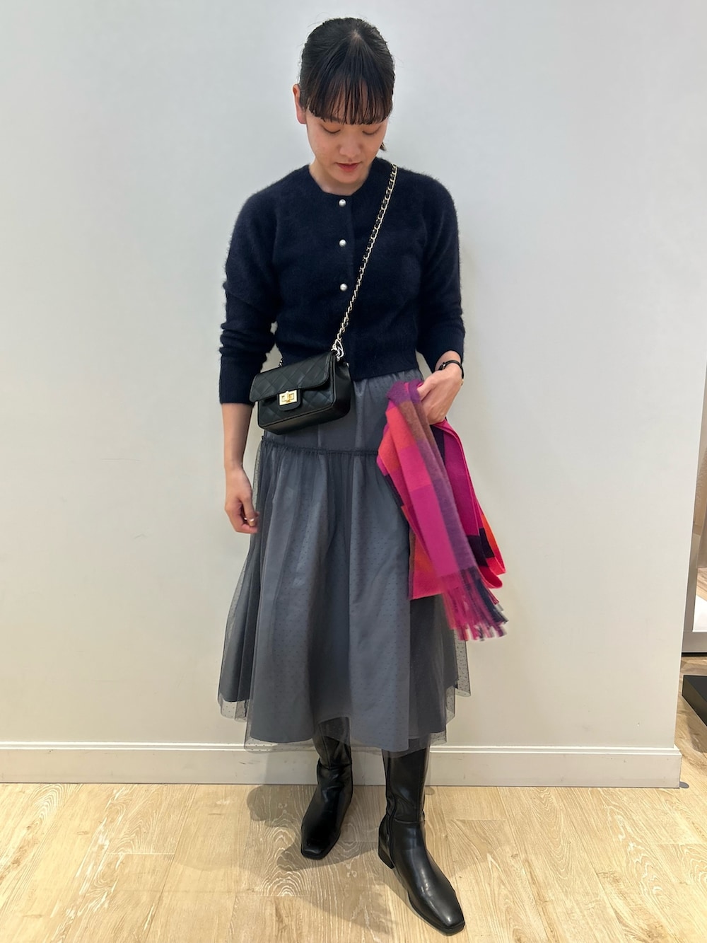 ブルー系のカーディガン/ボレロ、グリーン系のスカート、ピンク系のストール/ショールを着用したレディースの冬コーディネートの2枚目の写真