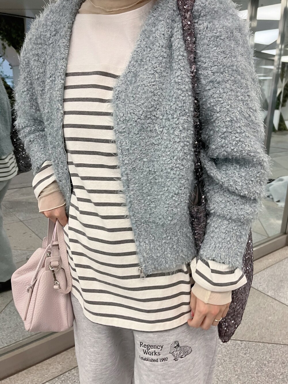 グレー系のTシャツ/カットソー、ブルー系のカーディガン/ボレロを着用したレディースの冬コーディネートの5枚目の写真