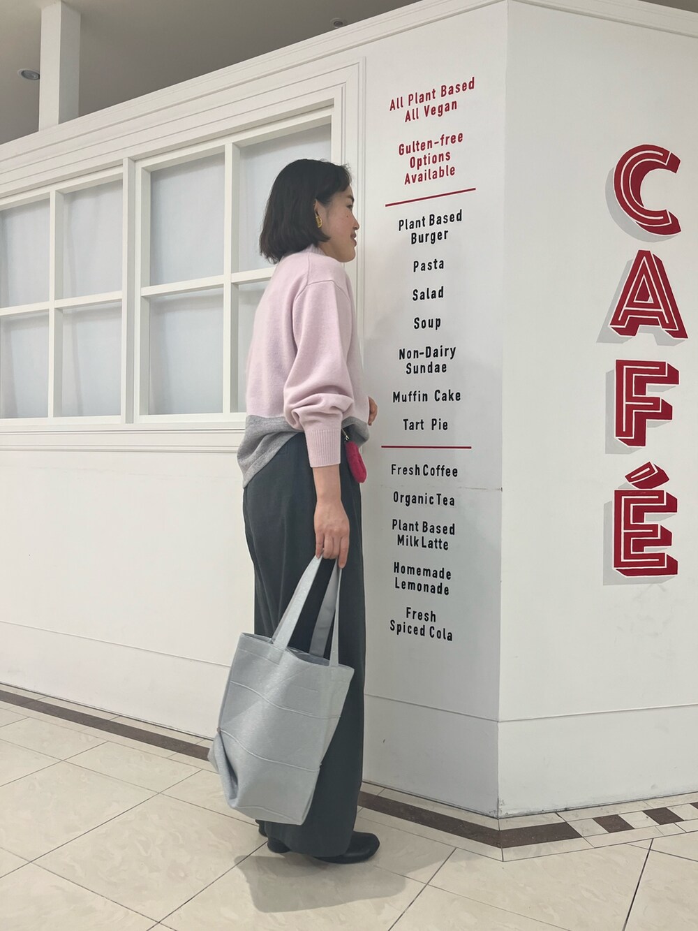 グレー系のその他パンツ、ピンク系のニット/セーター、シルバー系のトートバッグを着用したレディースの冬コーディネートの5枚目の写真