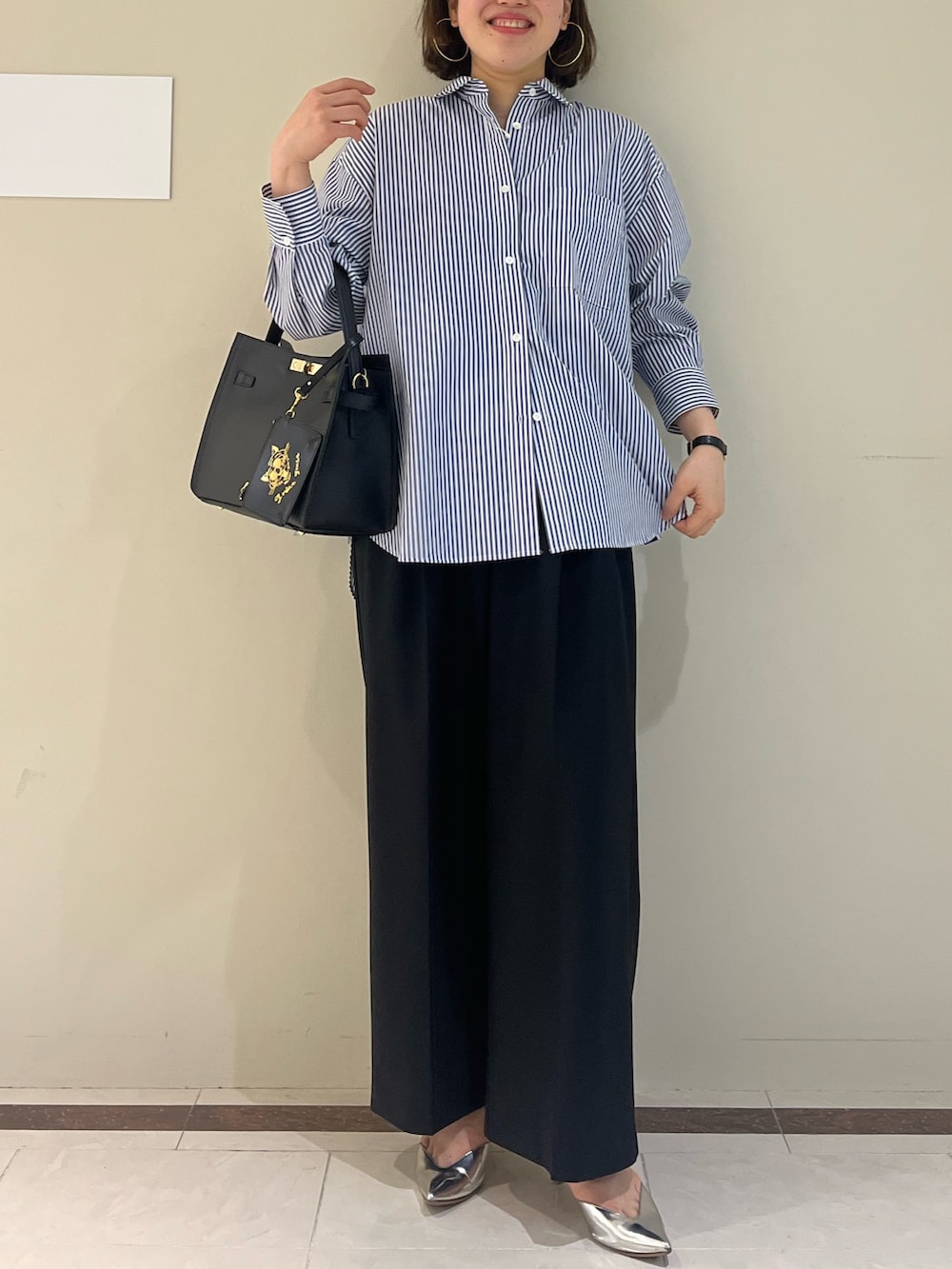 ブラック系のその他パンツ、ブルー系のシャツ/ブラウス、ブラック系のショルダーバッグを着用したレディースの春コーディネートの3枚目の写真