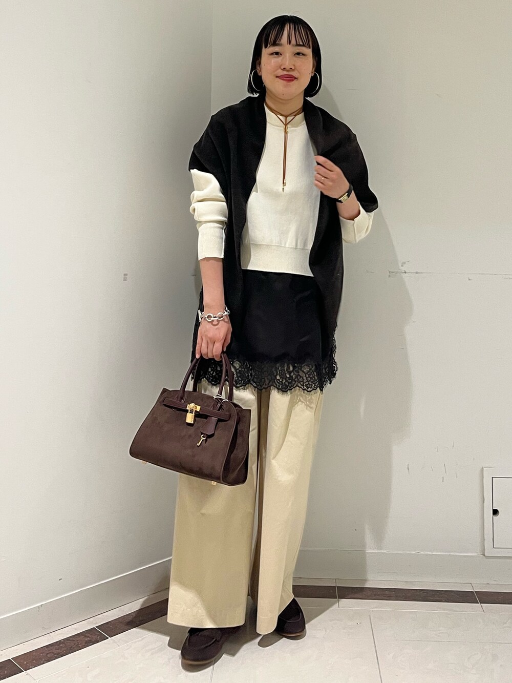 ホワイト系のニット/セーター、ホワイト系のその他パンツ、ブラウン系のトートバッグを着用したレディースの秋コーディネートの2枚目の写真