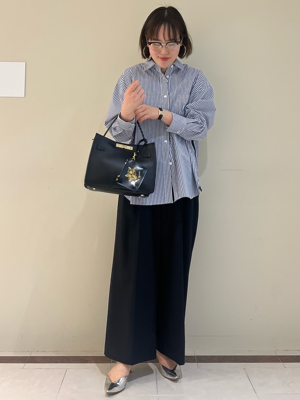 ブラック系のその他パンツ、ブルー系のシャツ/ブラウス、ブラック系のショルダーバッグを着用したレディースの春コーディネートの8枚目の写真