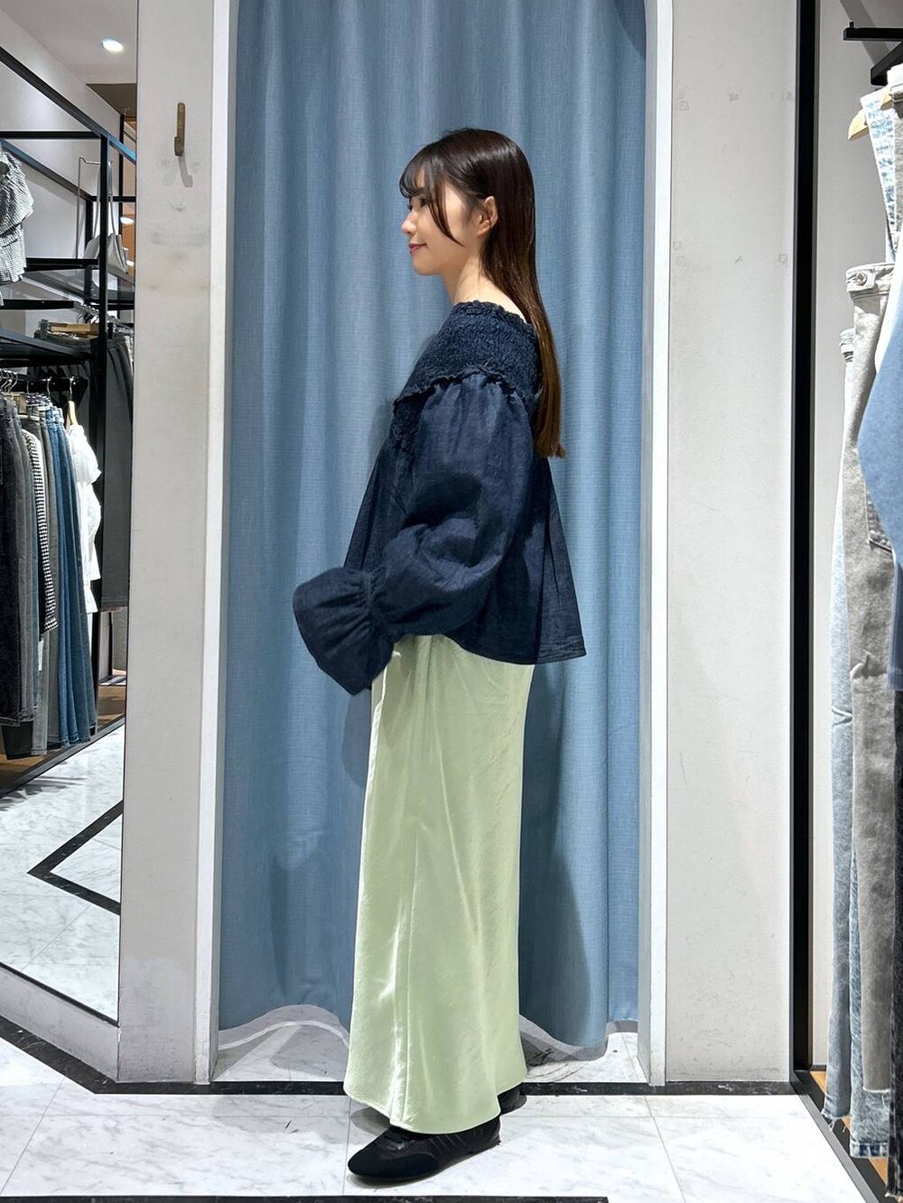 ブルー系のシャツ/ブラウス、ブラック系のスニーカー、グリーン系のスカートを着用したレディースの春コーディネートの5枚目の写真