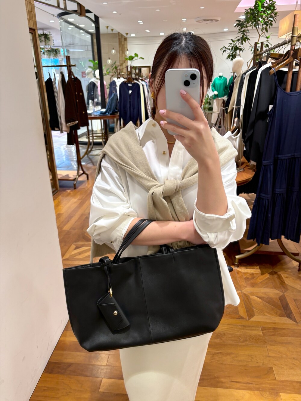 ホワイト系のシャツ/ブラウス、ホワイト系のスカート、ブラック系のトートバッグを着用したレディースの冬コーディネートの5枚目の写真