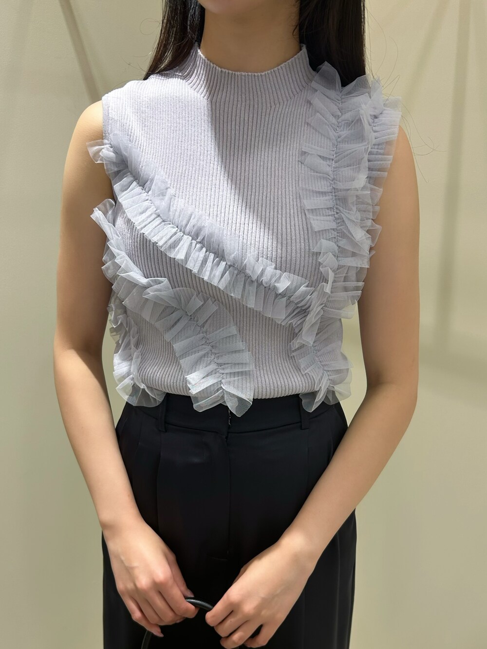 グレー系のニット/セーター、ブルー系のその他パンツ、ブラック系のボストンバッグを着用したレディースの夏コーディネートの4枚目の写真