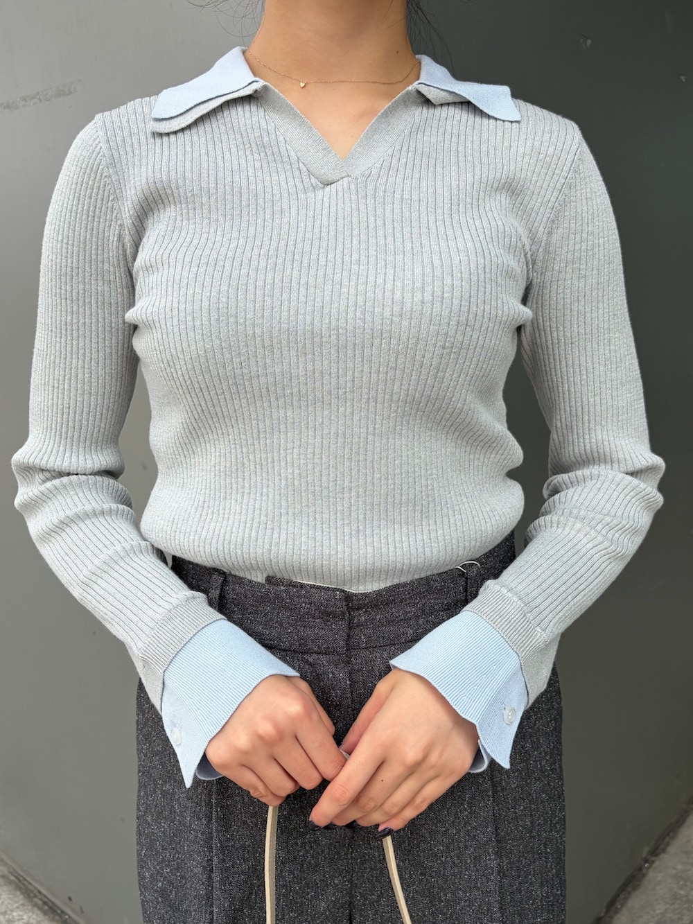 グレー系のニット/セーター、グレー系のその他パンツ、ホワイト系のショルダーバッグを着用したレディースの秋コーディネートの6枚目の写真