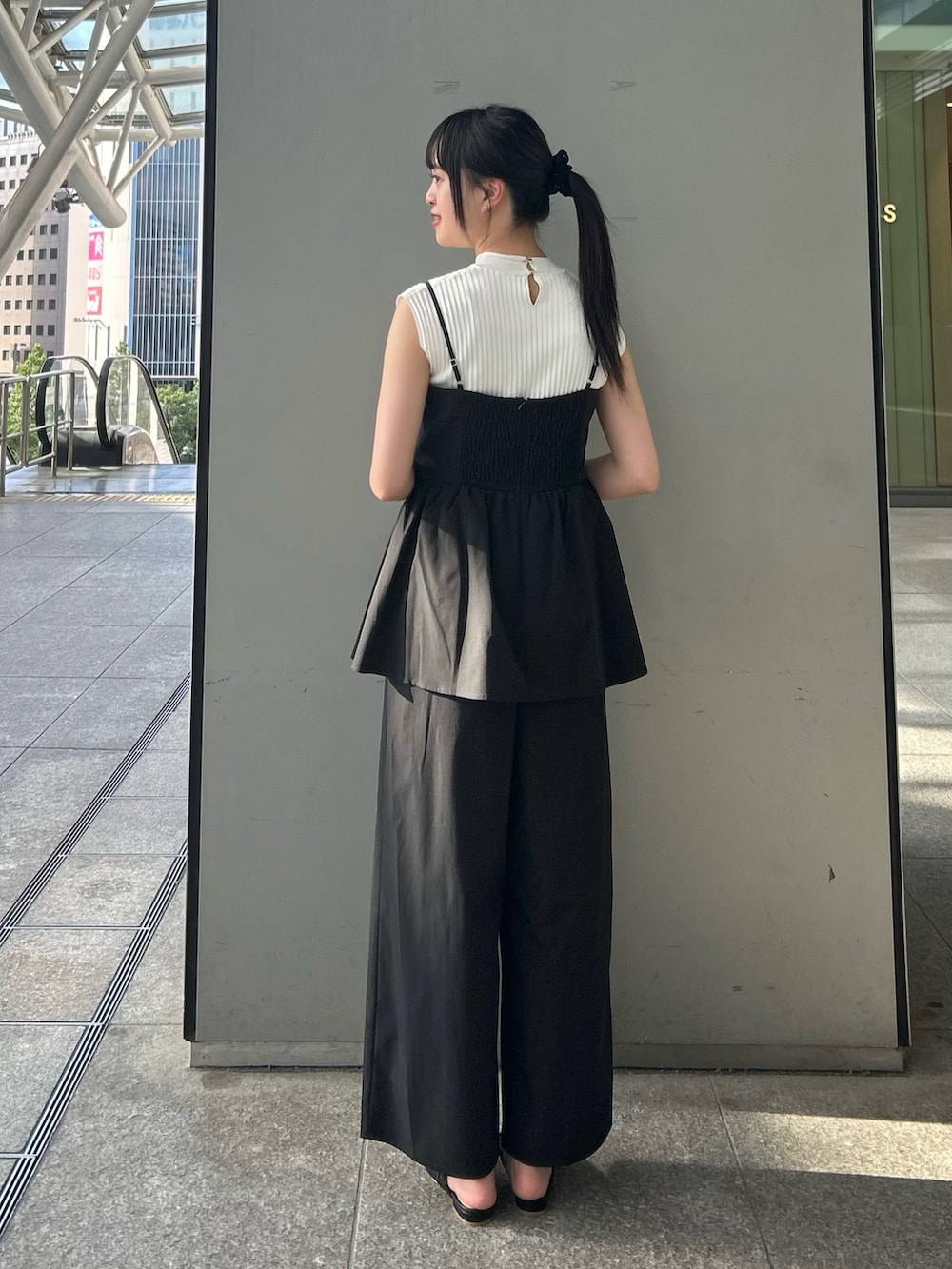 ホワイト系のニット/セーター、ブラック系のつなぎ/オールインワンを着用したレディースの夏コーディネートの4枚目の写真