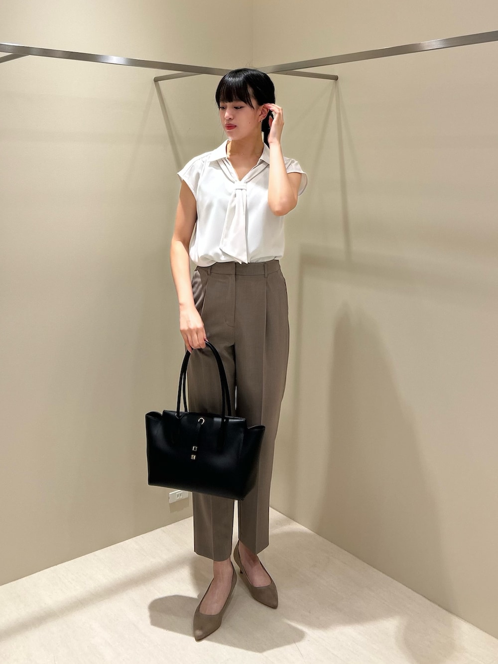 ホワイト系のシャツ/ブラウス、ベージュ系のその他パンツ、ブラック系のトートバッグを着用したレディースの夏コーディネートの2枚目の写真