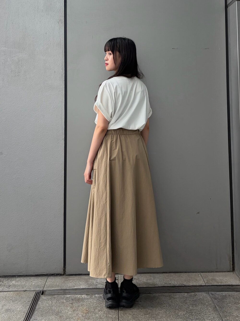 ベージュ系のスカート、ホワイト系のTシャツ/カットソーを着用したレディースの夏コーディネートの4枚目の写真