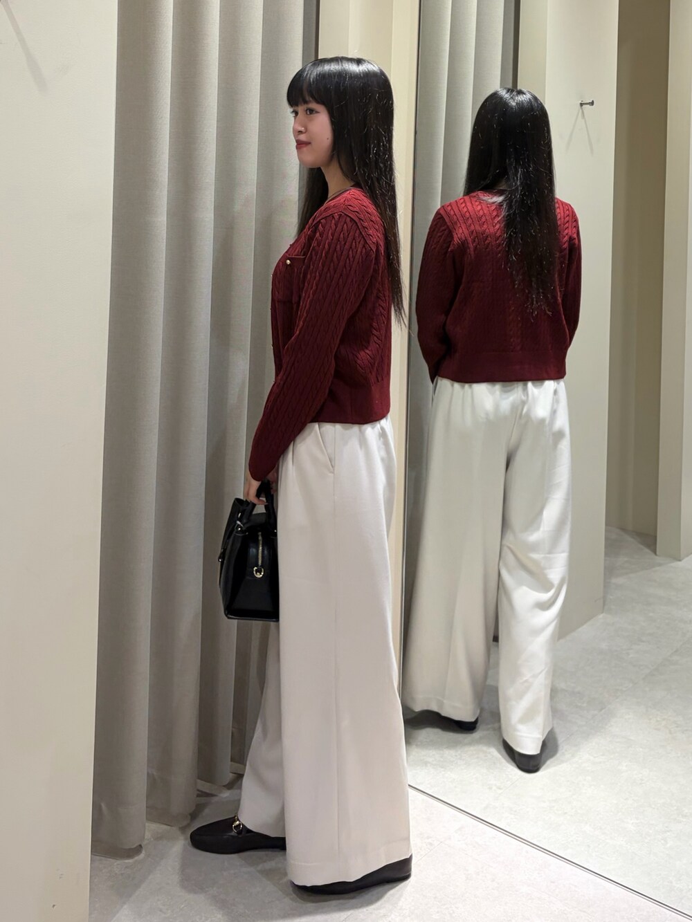 レッド系のアンサンブル、ホワイト系のその他パンツ、ブラック系のショルダーバッグを着用したレディースの秋コーディネートの4枚目の写真