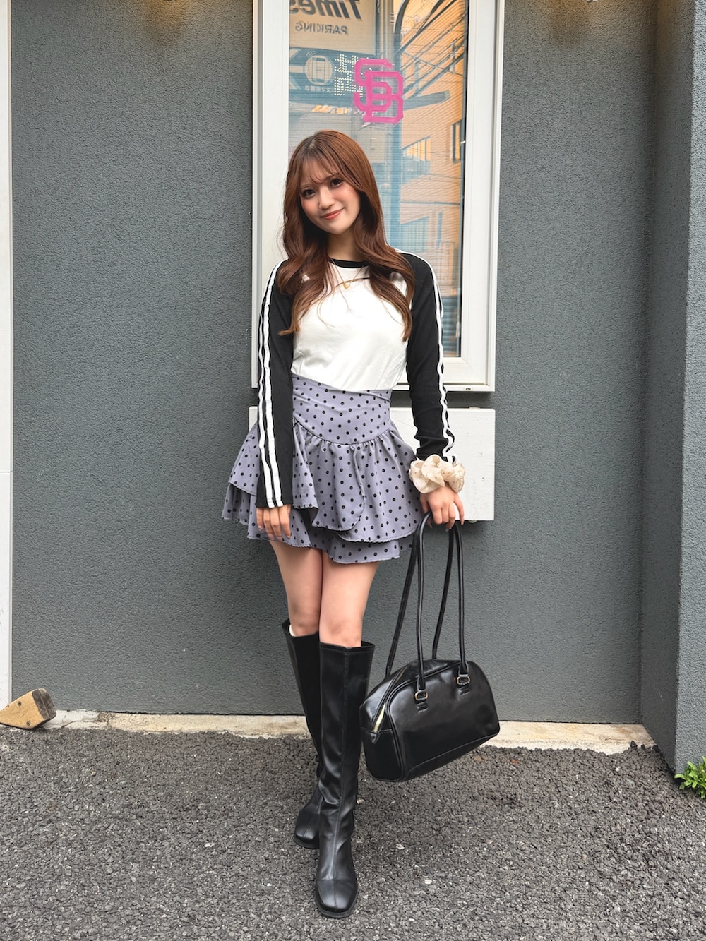 ブラック系のボストンバッグ、ホワイト系のTシャツ/カットソーを着用したレディースの春コーディネートの2枚目の写真