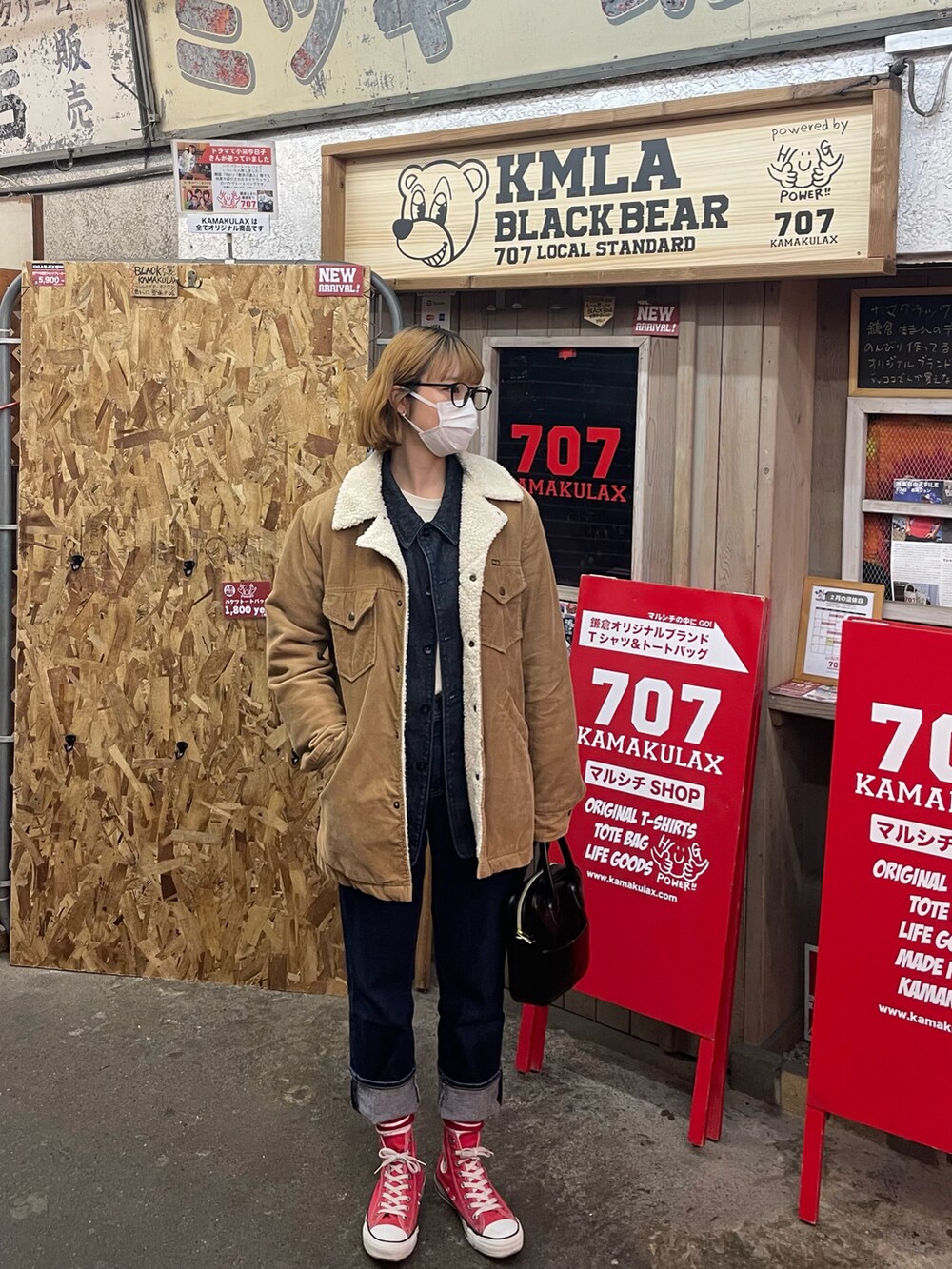 ブルー系のデニムジャケット、ブルー系のデニムパンツ、レッド系のスニーカーを着用したレディースの冬コーディネートの2枚目の写真