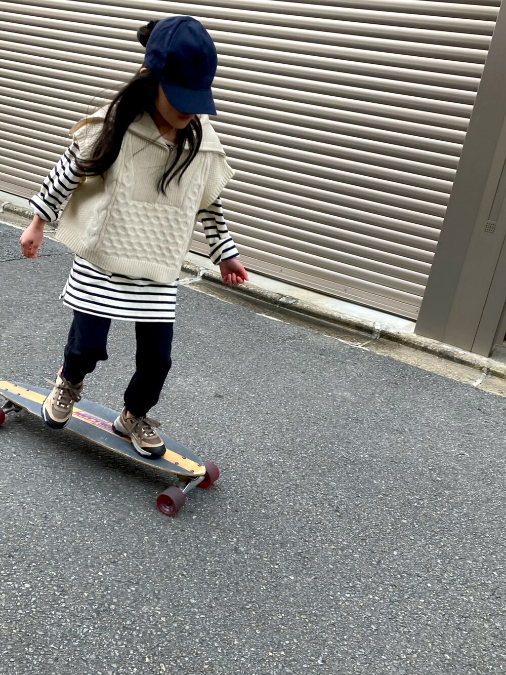 ブラック系のスウェットパンツ、ホワイト系のベスト、ブラック系のキャップを着用したキッズの冬コーディネートの4枚目の写真