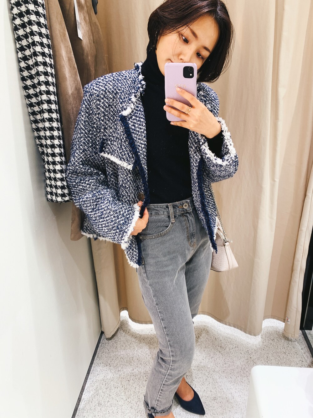 ブルー系のパンプス、ブラック系のニット/セーター、ホワイト系のショルダーバッグを着用したレディースの秋コーディネートの2枚目の写真