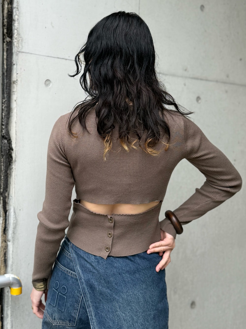 ブラウン系のショルダーバッグ、イエロー系のサンダル、グリーン系のニット/セーターを着用したレディースの春コーディネートの2枚目の写真