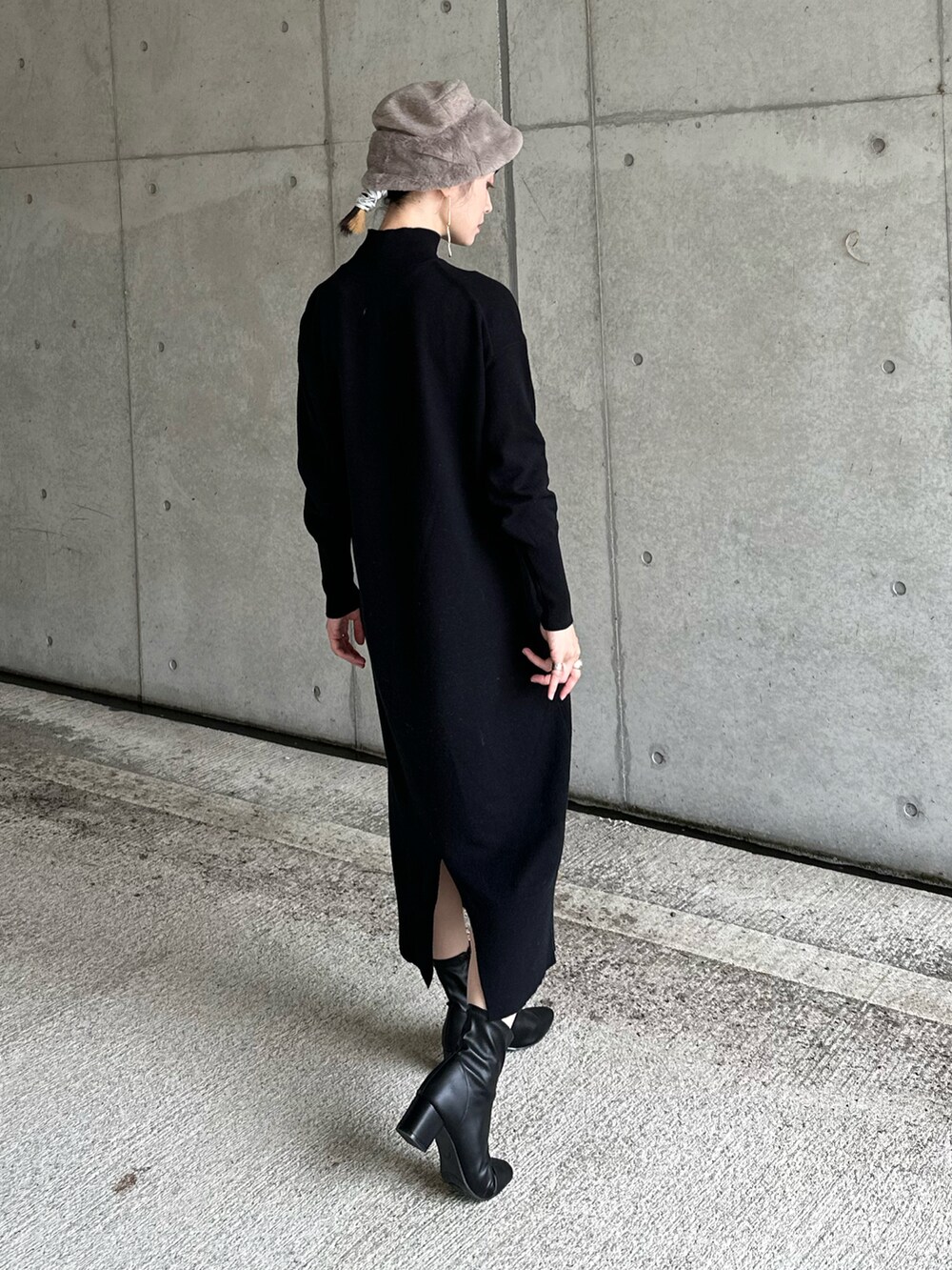 ブラウン系のダウンジャケット/コート、ブラック系のワンピース、ブラック系のブーツを着用したレディースの秋コーディネートの3枚目の写真