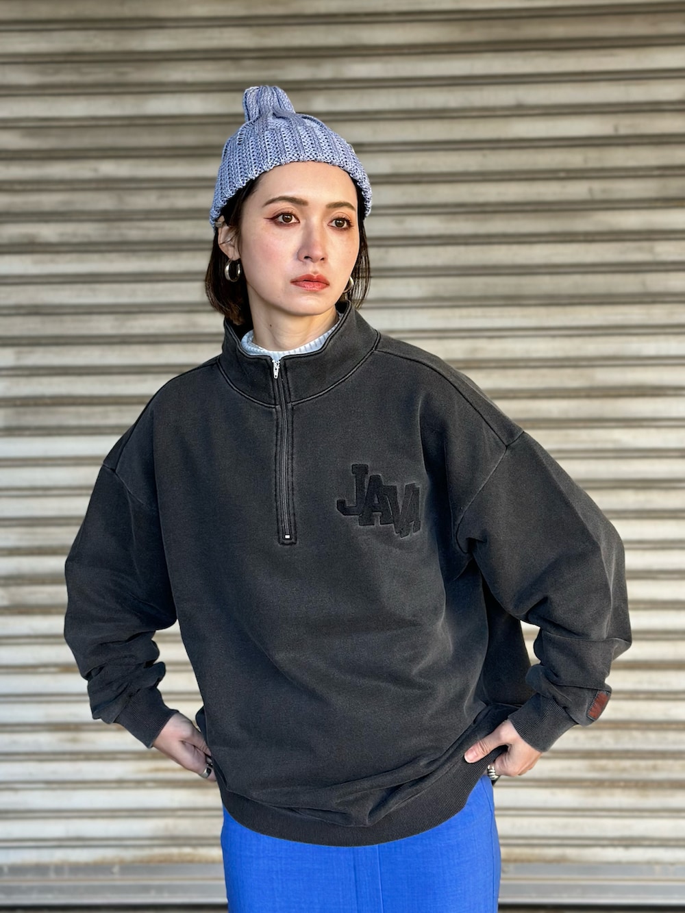 グレー系のスウェット、ブルー系のスニーカー、ホワイト系のトートバッグを着用したレディースの春コーディネートの2枚目の写真