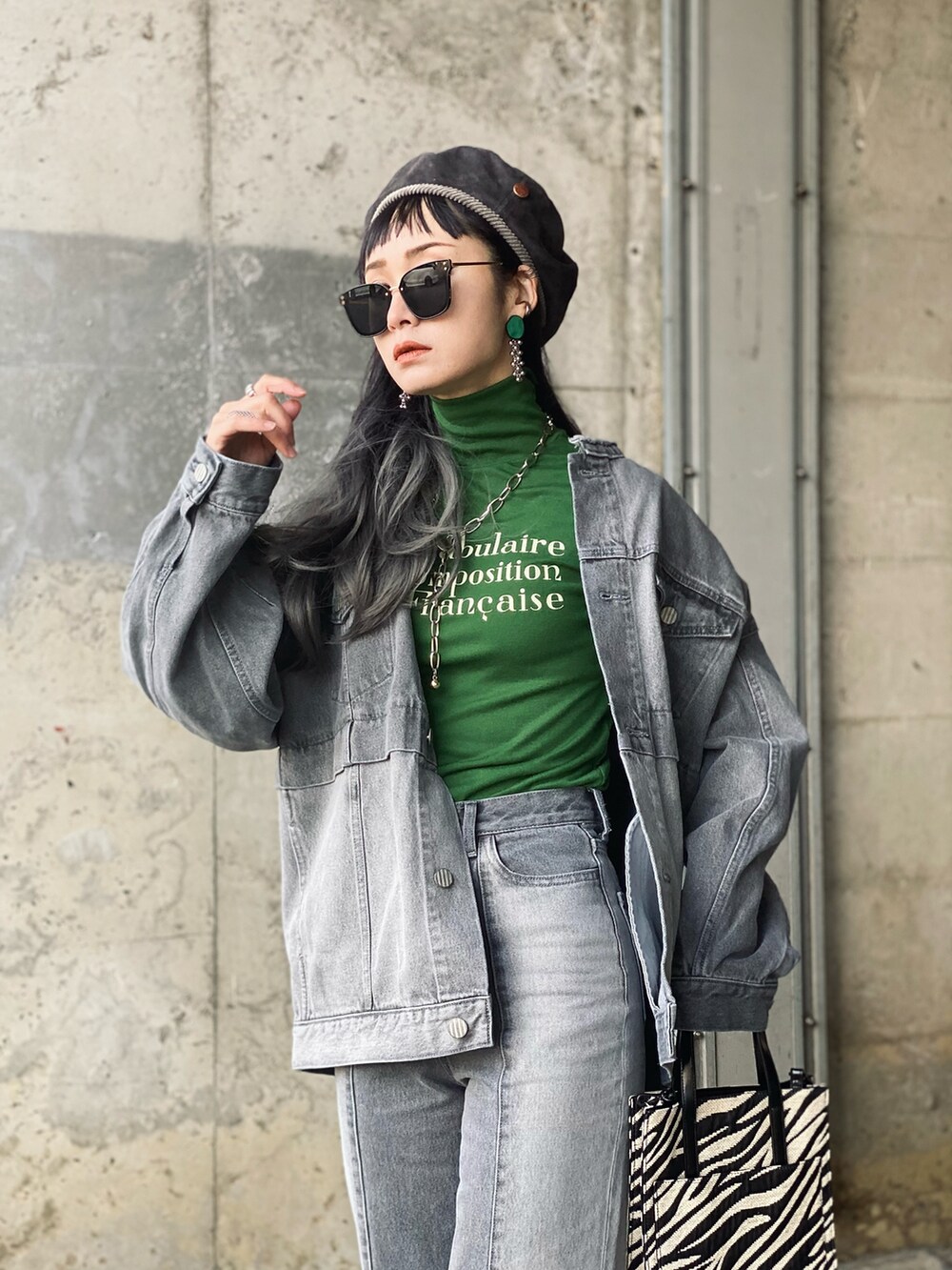 グレー系のデニムジャケット、グレー系のデニムパンツ、ブラック系のブーツを着用したレディースの冬コーディネートの5枚目の写真