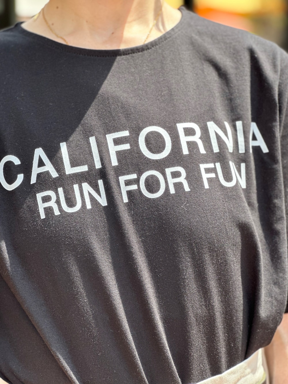 ブラック系のローファー、ブラック系のTシャツ/カットソー、ホワイト系のチノパンツを着用したレディースの春コーディネートの3枚目の写真