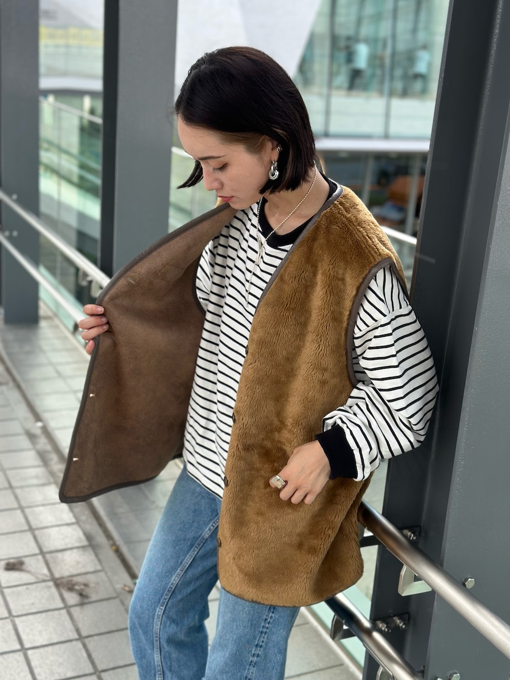 ブラウン系のベストを着用したレディースの秋コーディネートの3枚目の写真