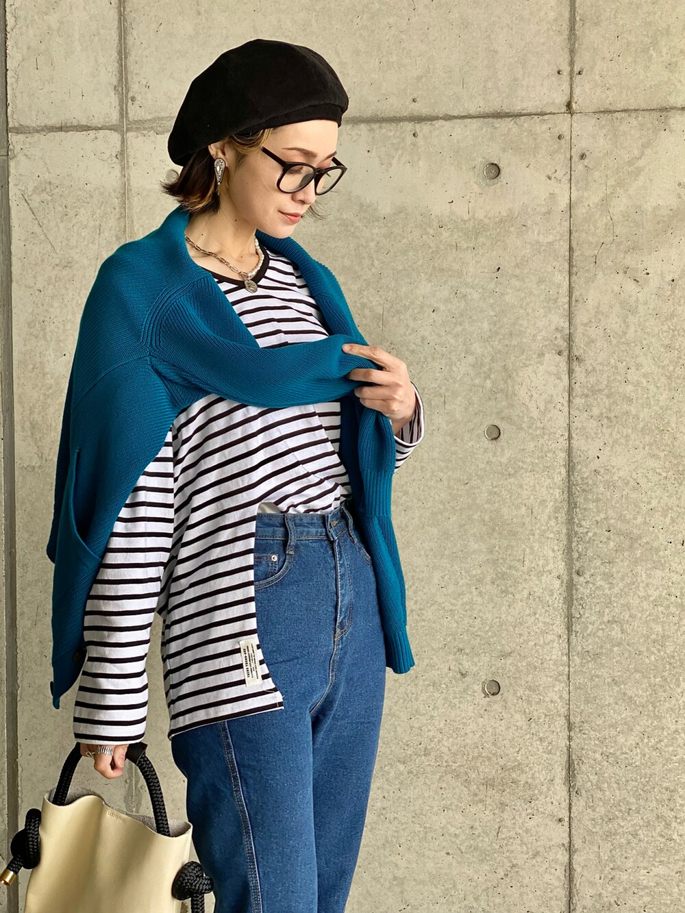 ブルー系のカーディガン/ボレロ、ブルー系のデニムパンツ、ホワイト系のTシャツ/カットソーを着用したレディースの冬コーディネートの5枚目の写真