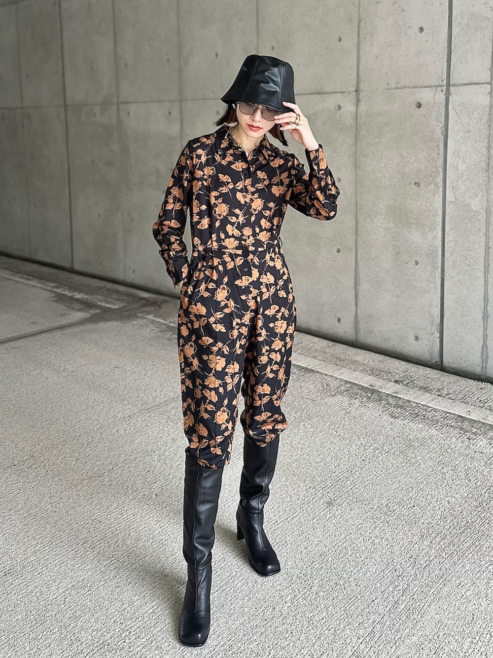 ブラウン系のスーツジャケット、ブルー系のつなぎ/オールインワン、ブラック系のブーツを着用したレディースの秋コーディネートの3枚目の写真