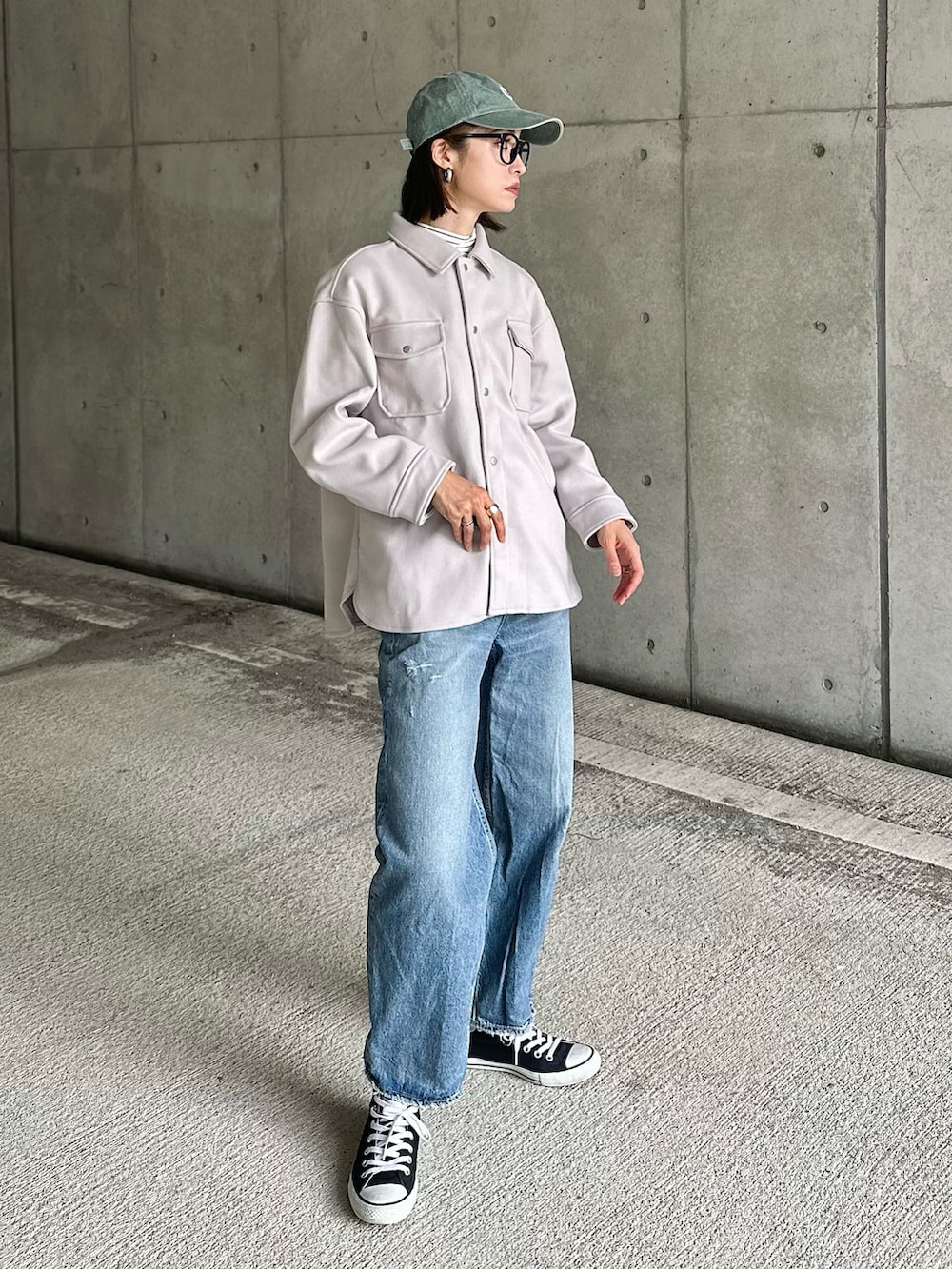 ブラウン系のスーツジャケット、ホワイト系のショルダーバッグ、ホワイト系のブーツを着用したレディースの秋コーディネートの2枚目の写真