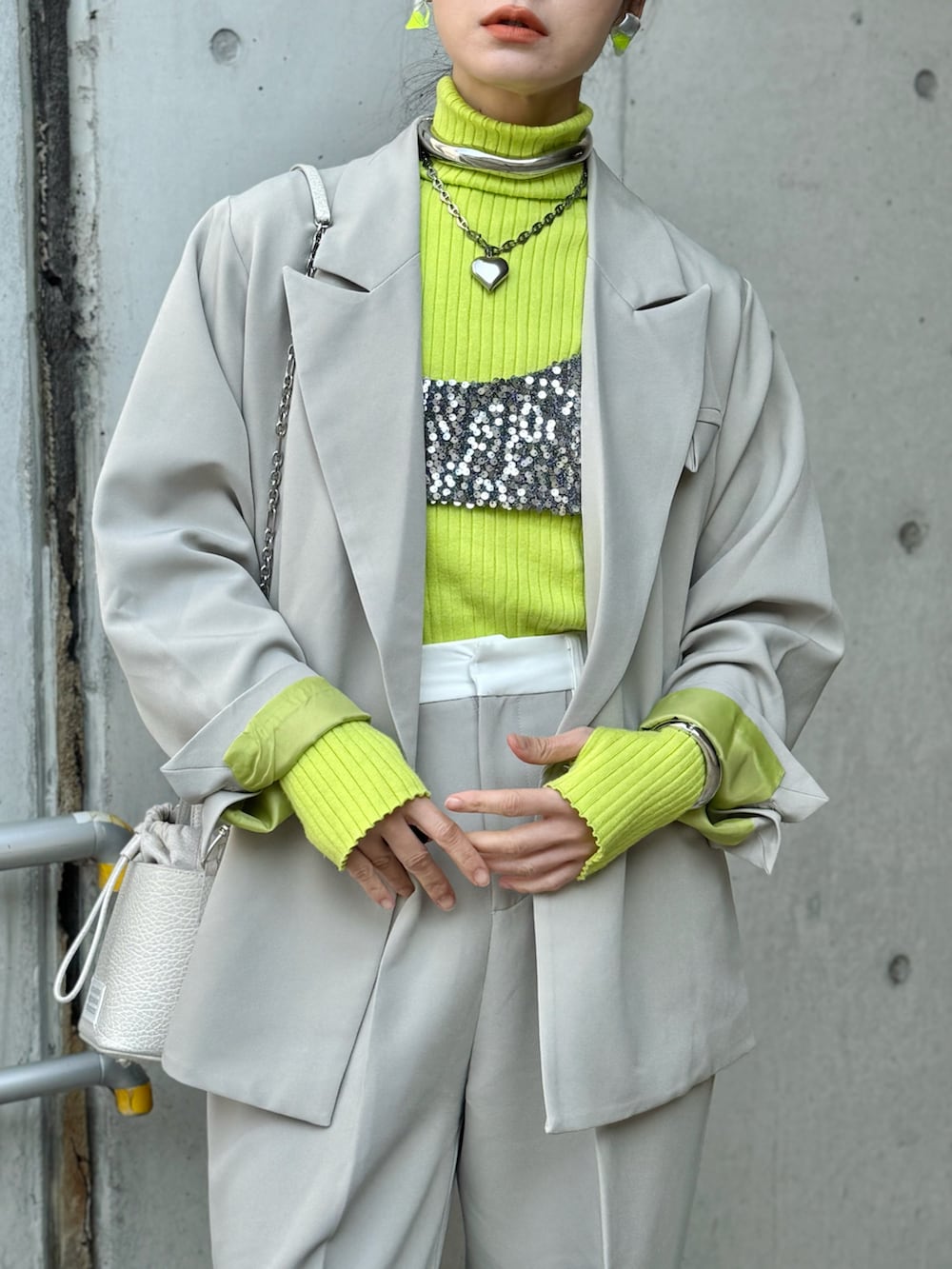 ベージュ系のテーラードジャケット、ベージュ系のスラックス、シルバー系のパンプスを着用したレディースの冬コーディネートの2枚目の写真