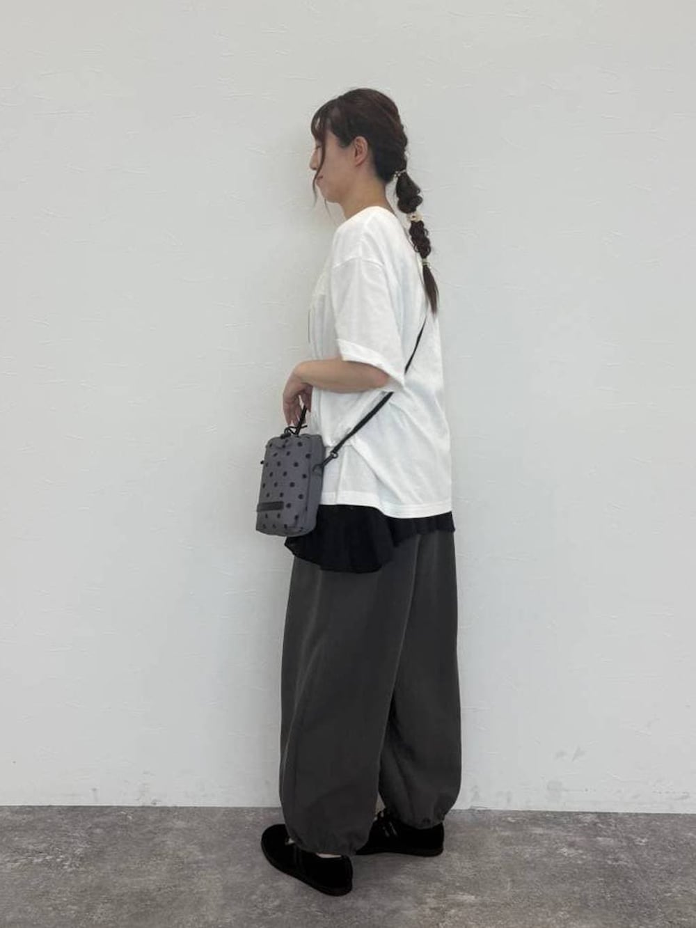 グレー系のショルダーバッグ、ホワイト系のTシャツ/カットソー、グレー系のその他パンツを着用したレディースの秋コーディネートの4枚目の写真