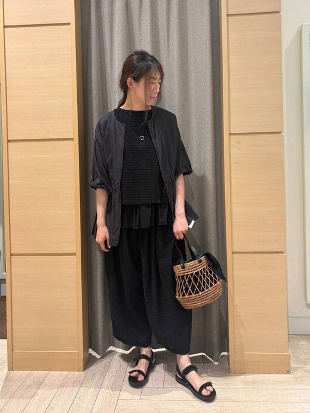 ブラック系のトートバッグ、ブラック系のサンダル、その他のブルゾンを着用したレディースの春コーディネートの3枚目の写真