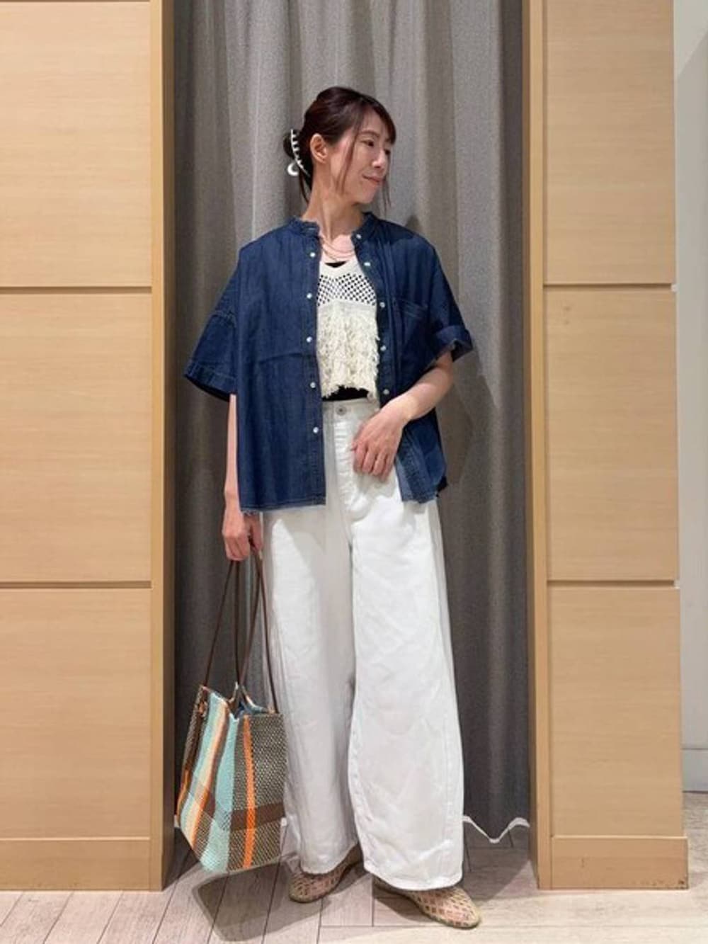 ブラウン系のトートバッグ、ブラック系のタンクトップ、ベージュ系のパンプスを着用したレディースの夏コーディネートの4枚目の写真