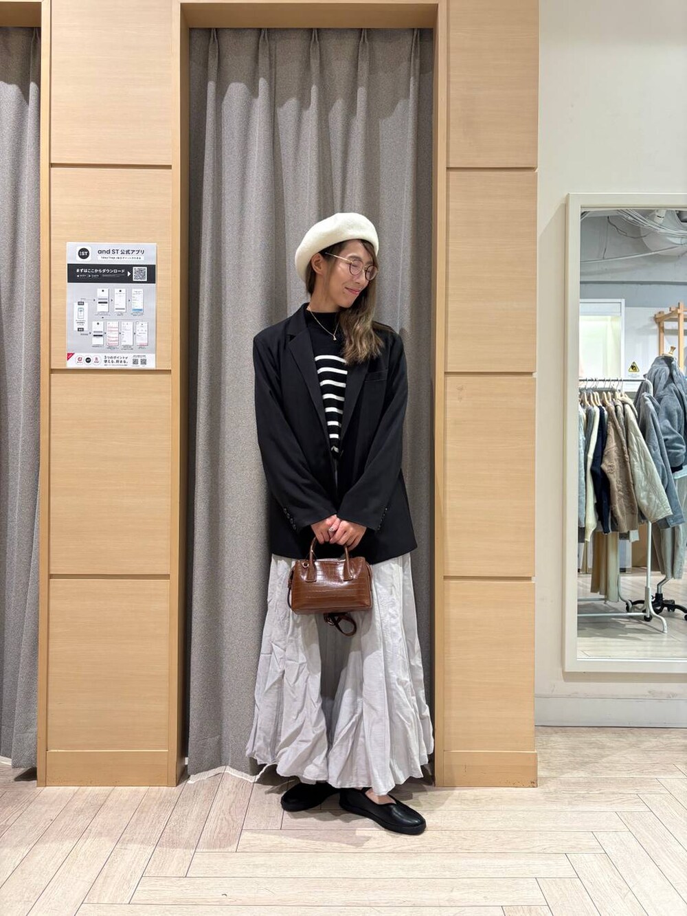 ブラック系のスニーカー、ブラウン系のトートバッグ、その他のニット/セーターを着用したレディースの冬コーディネートの6枚目の写真