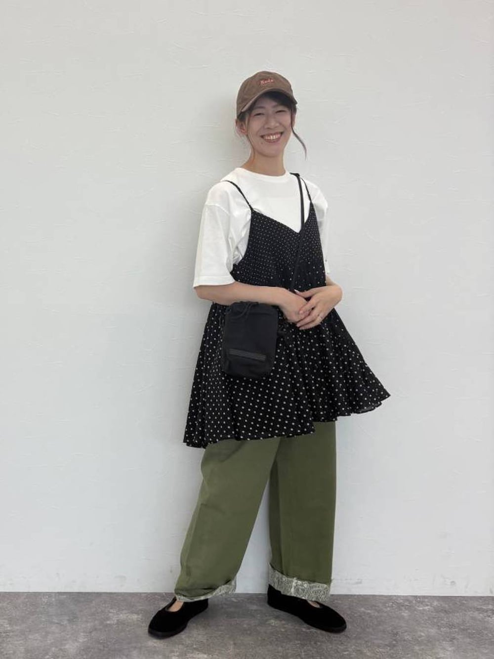 グリーン系のデニムパンツ、ホワイト系のTシャツ/カットソー、ブラック系のショルダーバッグを着用したレディースの秋コーディネートの3枚目の写真