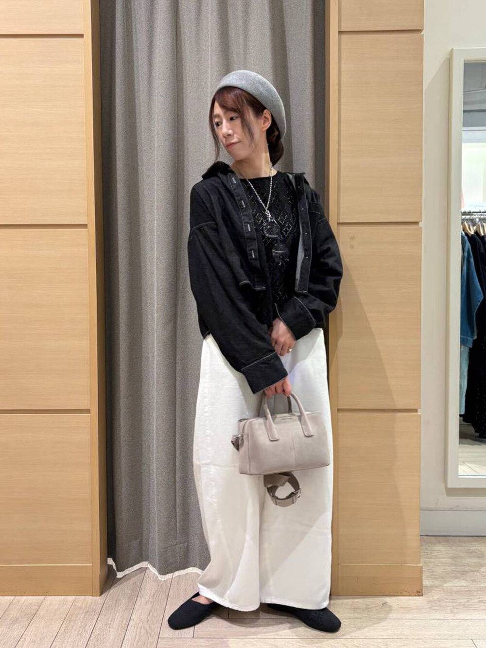 ホワイト系のデニムパンツ、グレー系のパンプス、ホワイト系のタンクトップを着用したレディースの春コーディネートの3枚目の写真
