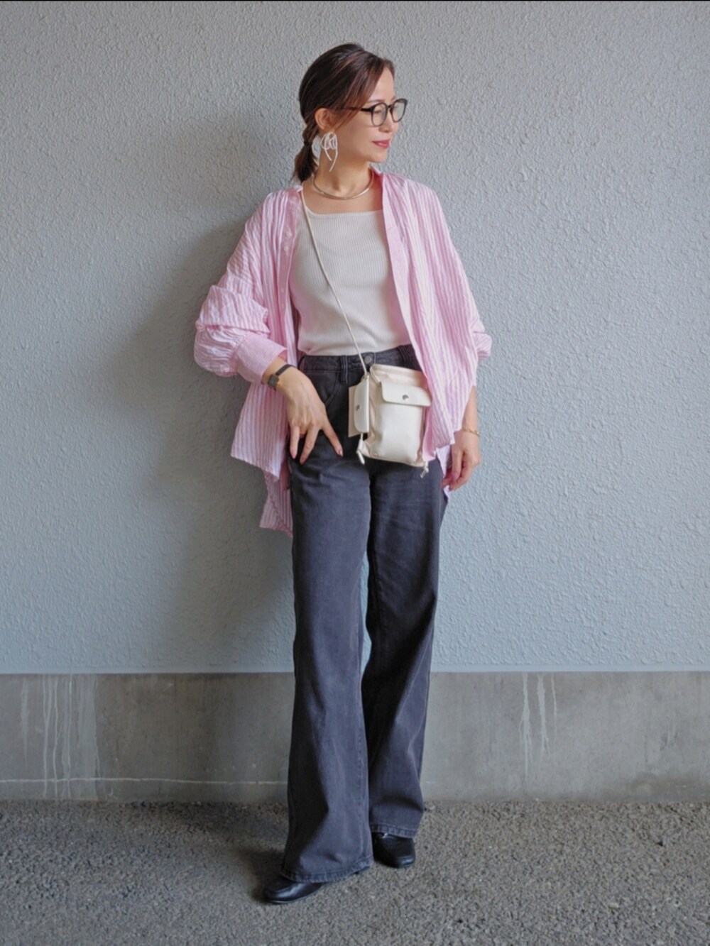 ホワイト系のタンクトップ、ブラック系のパンツ、ブラック系のパンプスを着用したレディースの春コーディネートの3枚目の写真