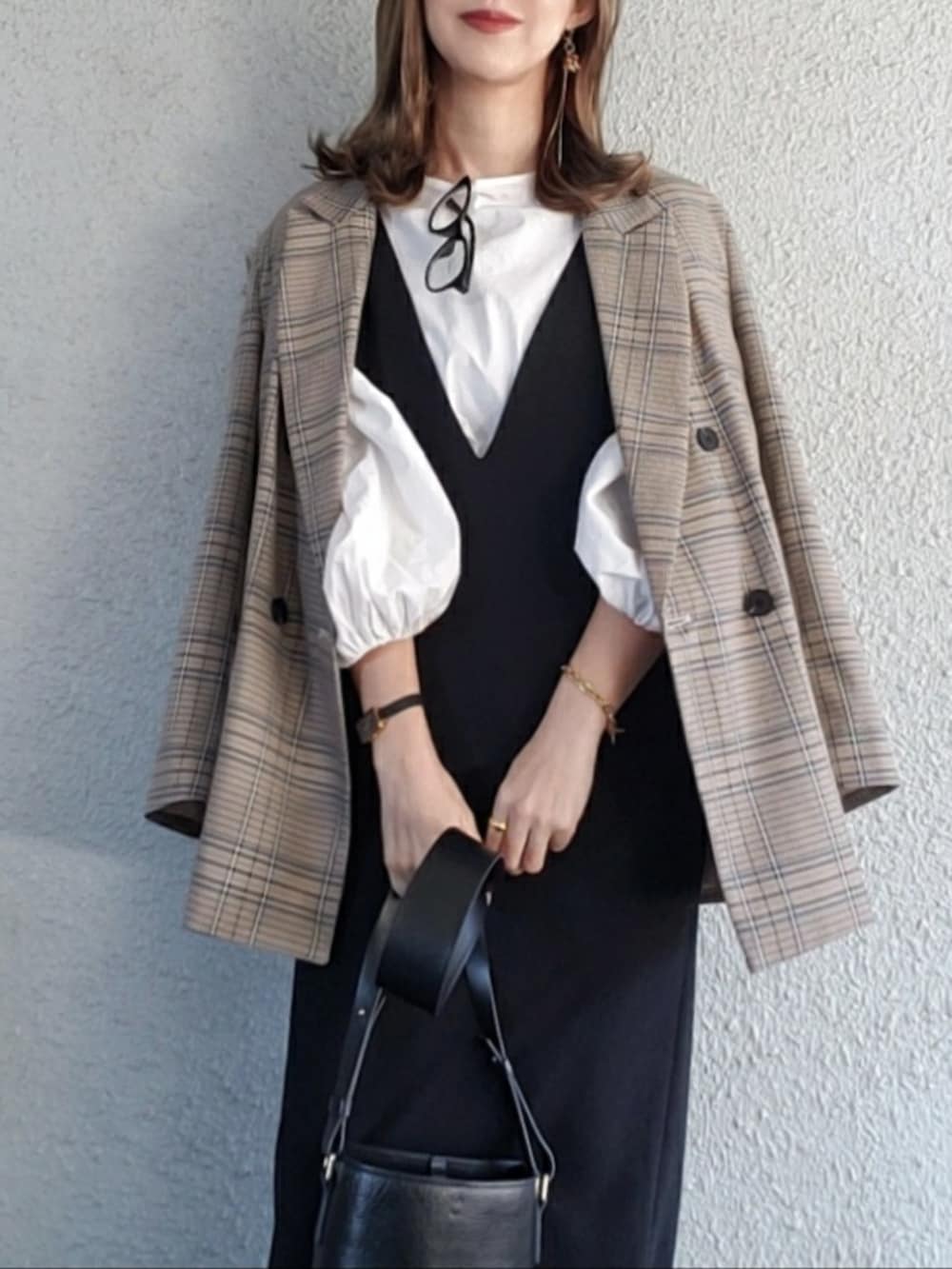 ブラック系のバッグ、ブラック系のワンピース、ブラック系のブーツを着用したレディースの冬コーディネートの4枚目の写真