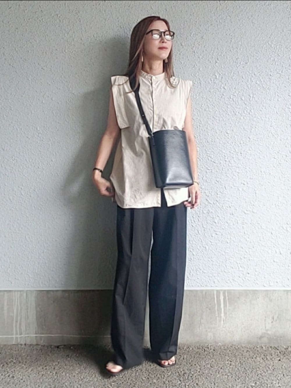 ベージュ系のシャツ/ブラウス、ブラック系のバッグ、ブラック系のサンダルを着用したレディースの夏コーディネートの2枚目の写真