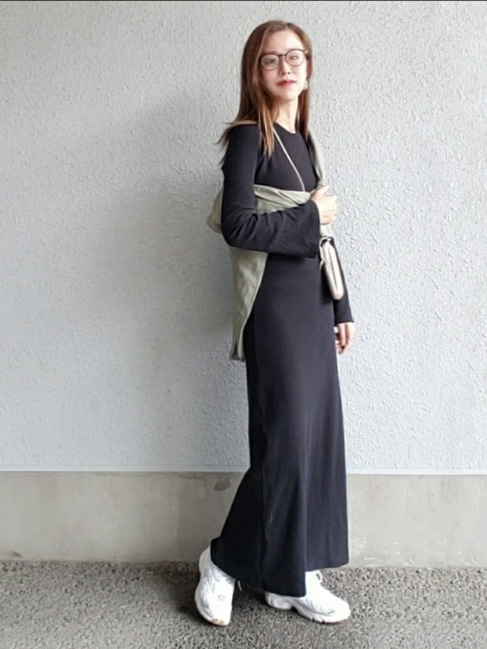 グリーン系のシャツ/ブラウス、ブラック系のワンピース、ベージュ系のスニーカーを着用したレディースの春コーディネートの2枚目の写真