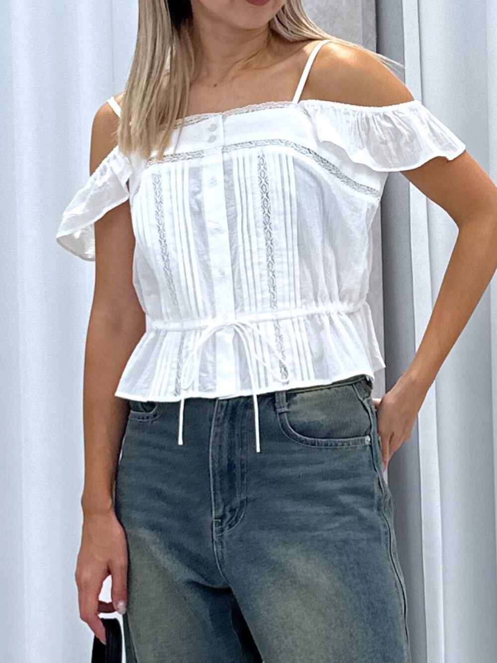 ホワイト系のシャツ/ブラウス、ブルー系のデニムパンツ、ブラック系のショルダーバッグを着用したレディースの夏コーディネートの4枚目の写真