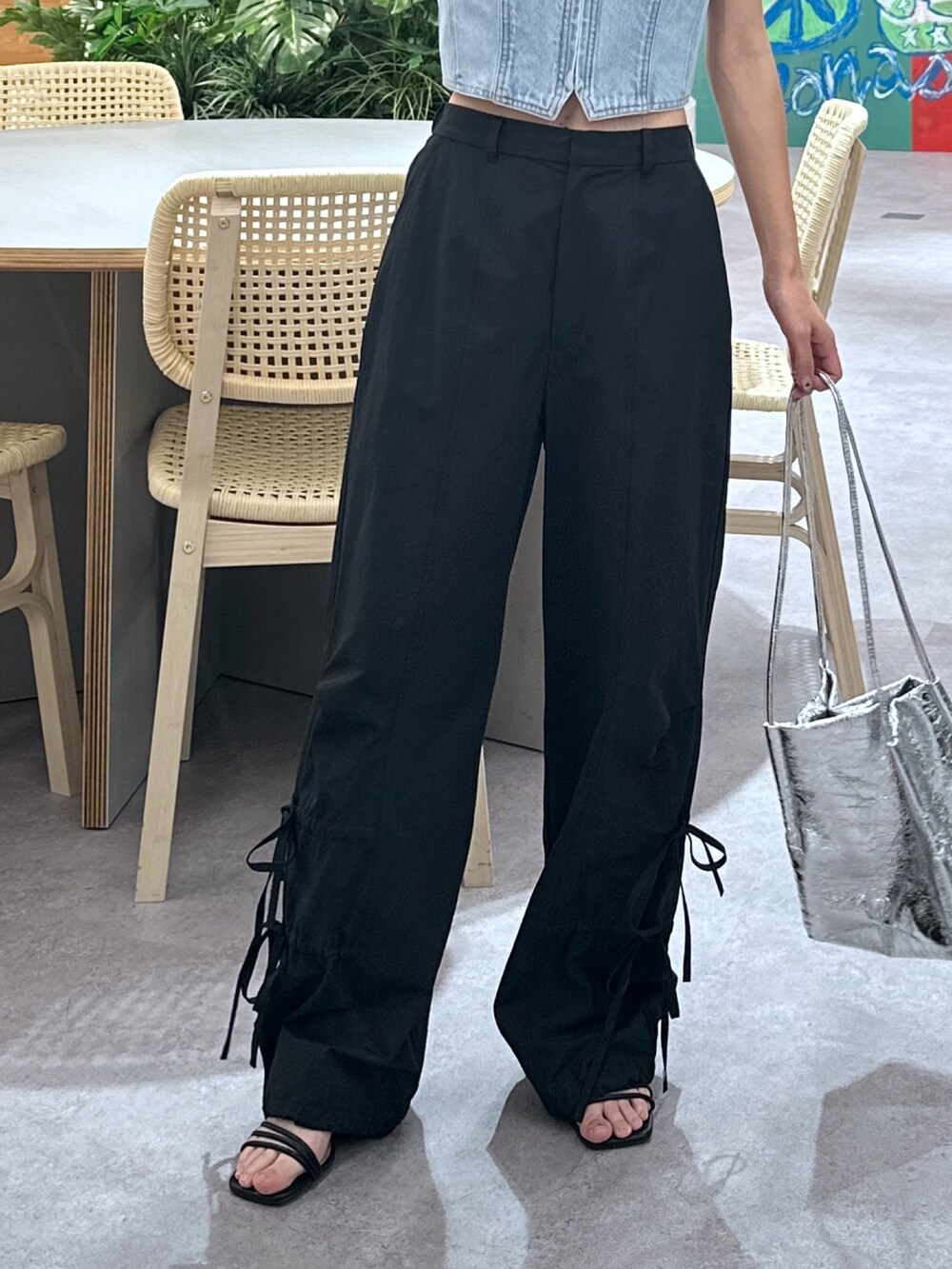 ブルー系のベスト、ブラック系のTシャツ/カットソー、ブラック系のカーゴパンツを着用したレディースの春コーディネートの5枚目の写真