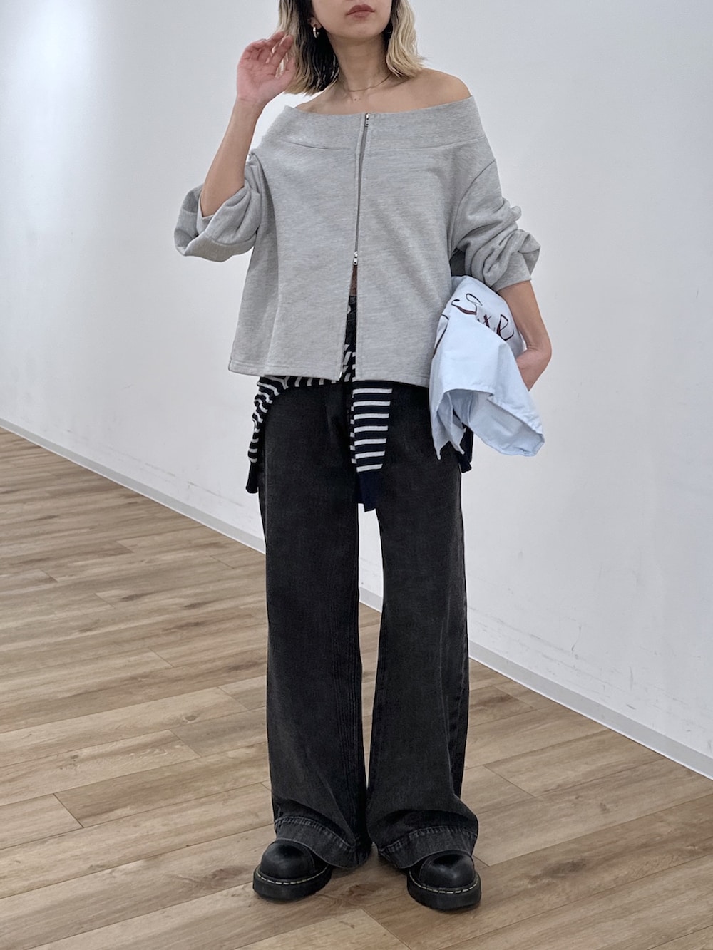 グレー系のTシャツ/カットソー、ブラック系のデニムパンツ、ブルー系のニット/セーターを着用したレディースの冬コーディネートの7枚目の写真