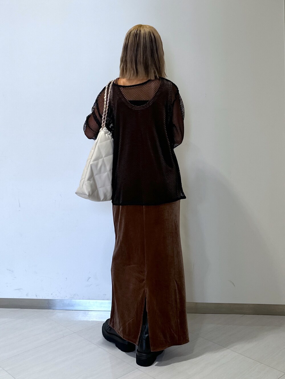 ブラウン系のワンピース、ブラック系のTシャツ/カットソー、ホワイト系のトートバッグを着用したレディースの秋コーディネートの3枚目の写真