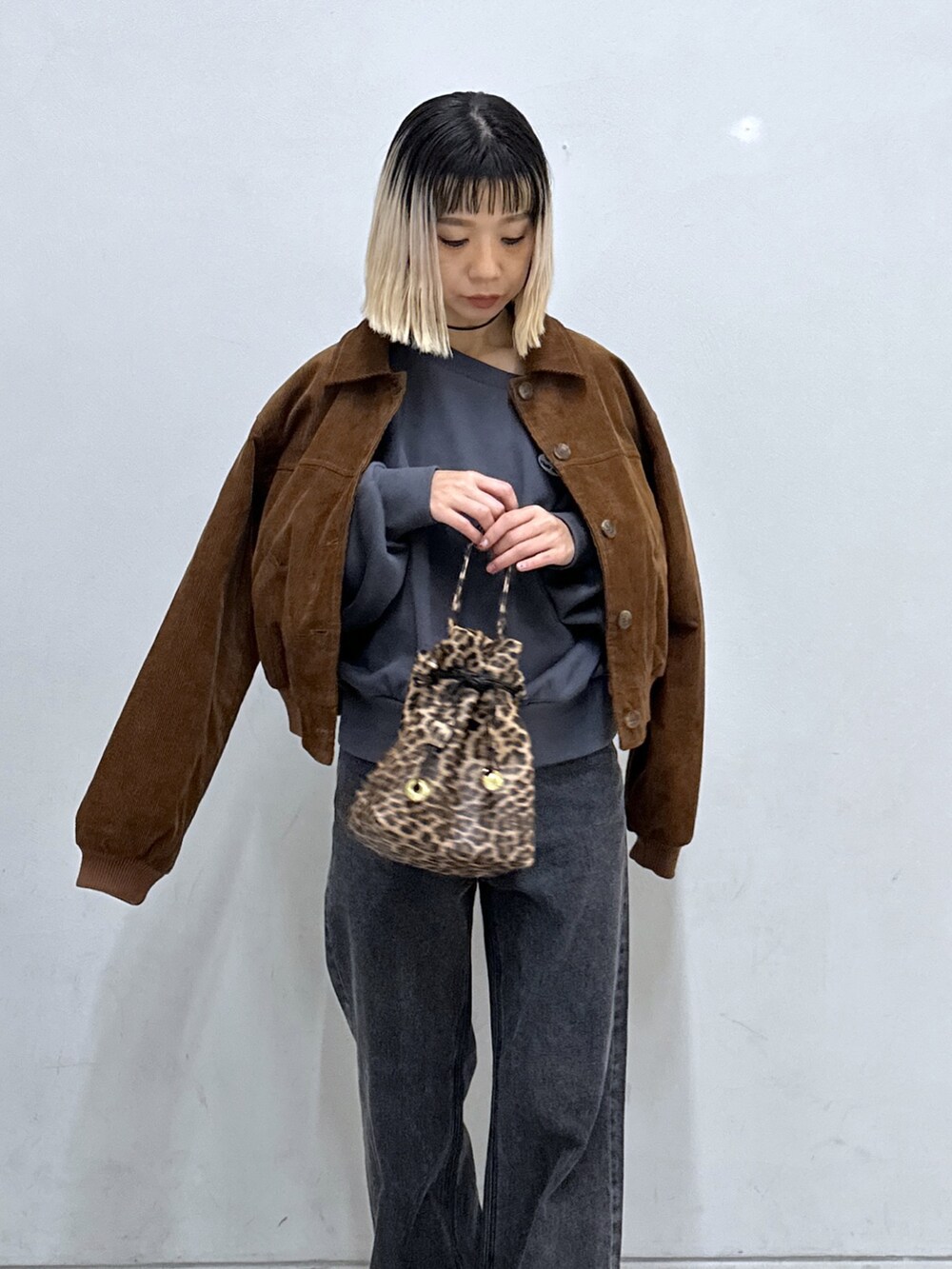 ブラック系のTシャツ/カットソー、ブラウン系のブルゾン、ブラック系のデニムパンツを着用したレディースの秋コーディネートの7枚目の写真