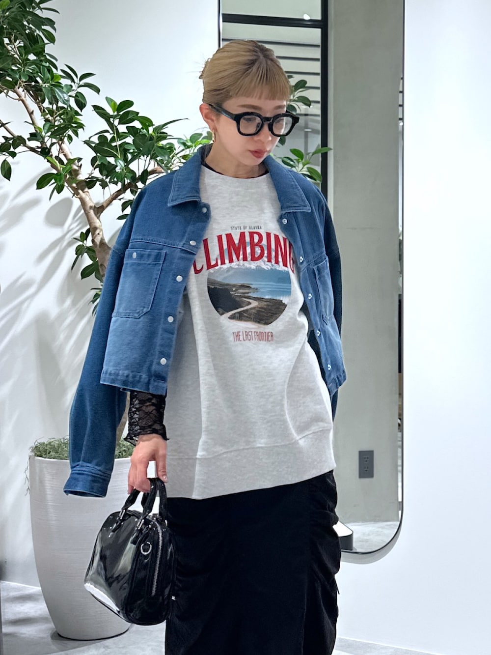 ホワイト系のスウェット、ブラック系のTシャツ/カットソー、ブルー系のブルゾンを着用したレディースの春コーディネートの6枚目の写真