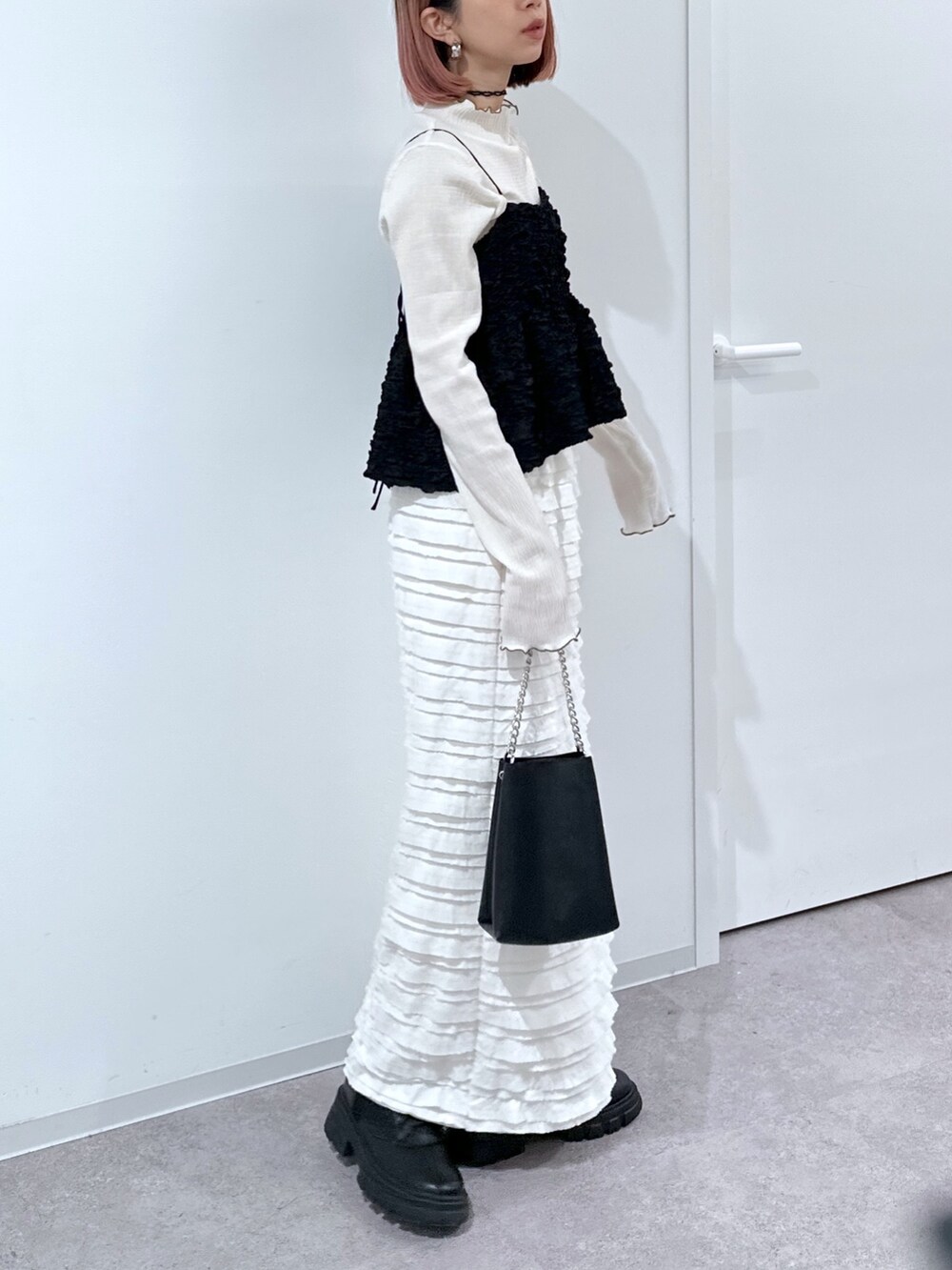 ホワイト系のTシャツ/カットソー、ブラック系のシャツ/ブラウス、ホワイト系のスカートを着用したレディースの春コーディネートの2枚目の写真