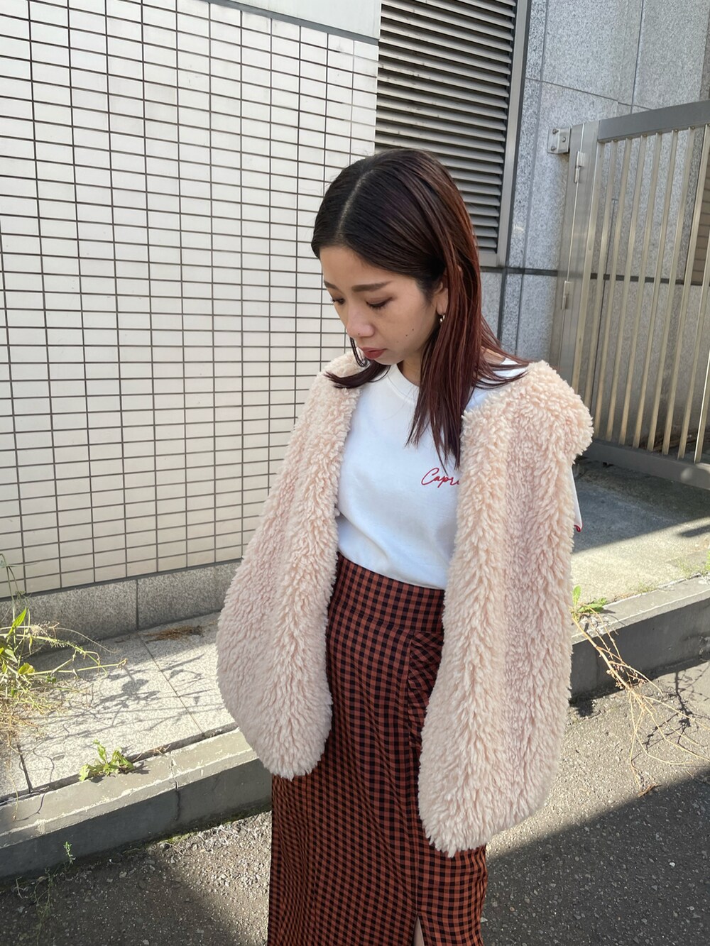 ブラウン系のスカート、ホワイト系のTシャツ/カットソーを着用したレディースの夏コーディネートの3枚目の写真