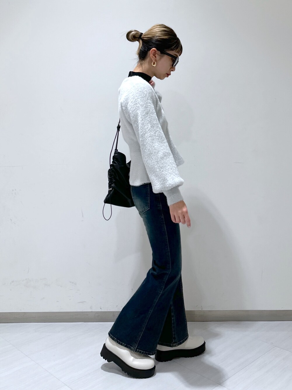 グレー系のカーディガン/ボレロ、ブラック系のニット/セーター、ブルー系のデニムパンツを着用したレディースの冬コーディネートの2枚目の写真
