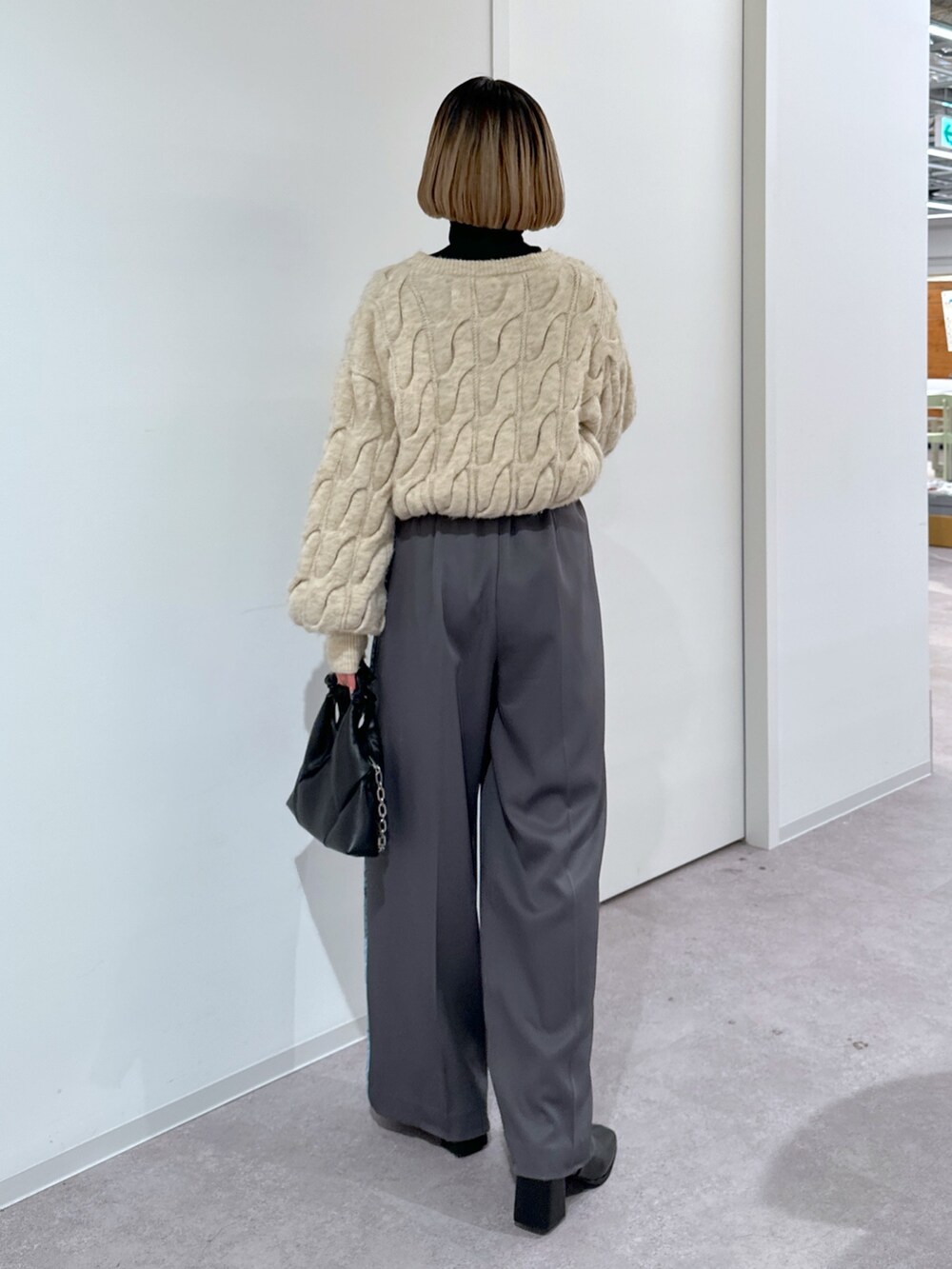 ホワイト系のニット/セーター、グレー系のその他パンツ、ブラック系のショルダーバッグを着用したレディースの冬コーディネートの3枚目の写真