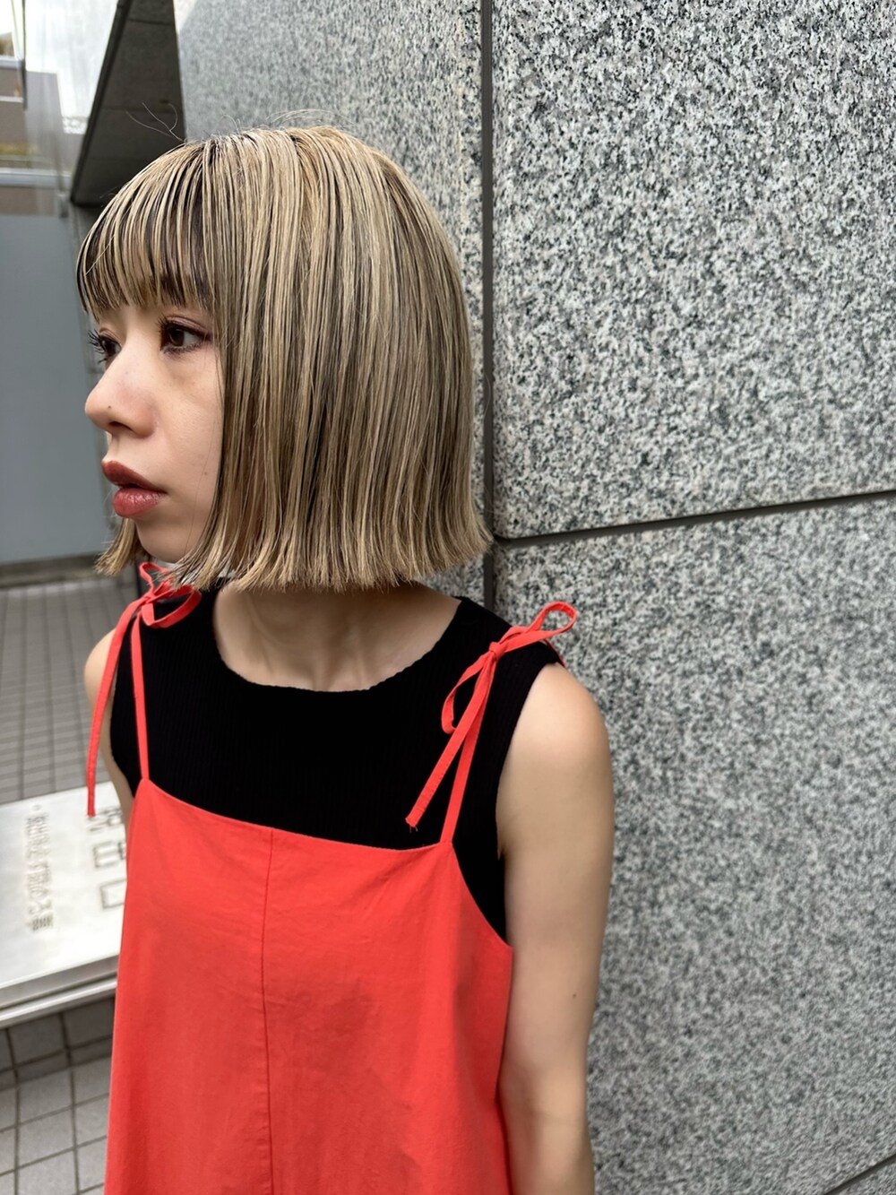 レッド系のワンピース、ブラック系のハンドバッグを着用したレディースの夏コーディネートの4枚目の写真